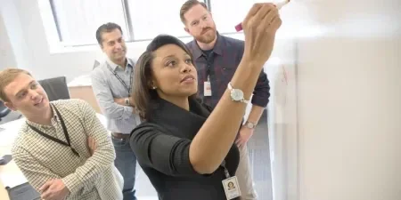 4 Gore associates working around a whiteboard