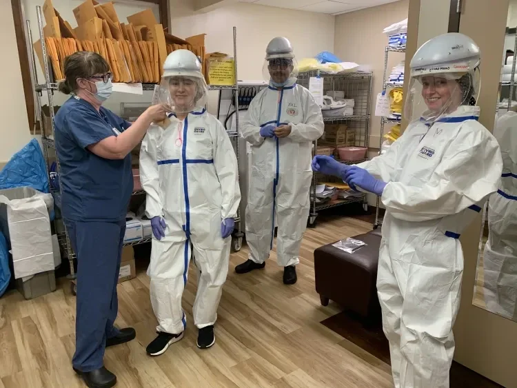 people putting on PPE