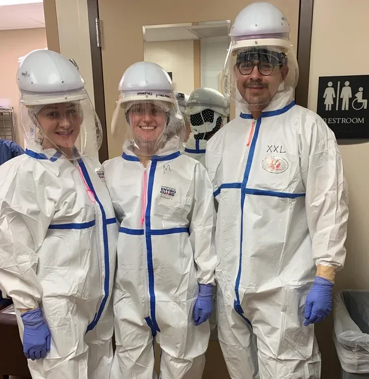 Three people in PPE
