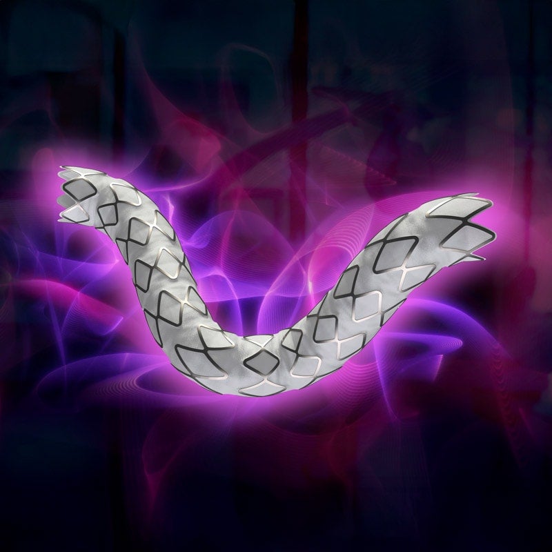 Product shot of the GORE® VIABAHN® VBX Balloon Expandable Endoprosthesis surrounded by a purple and pink glow over a dark background