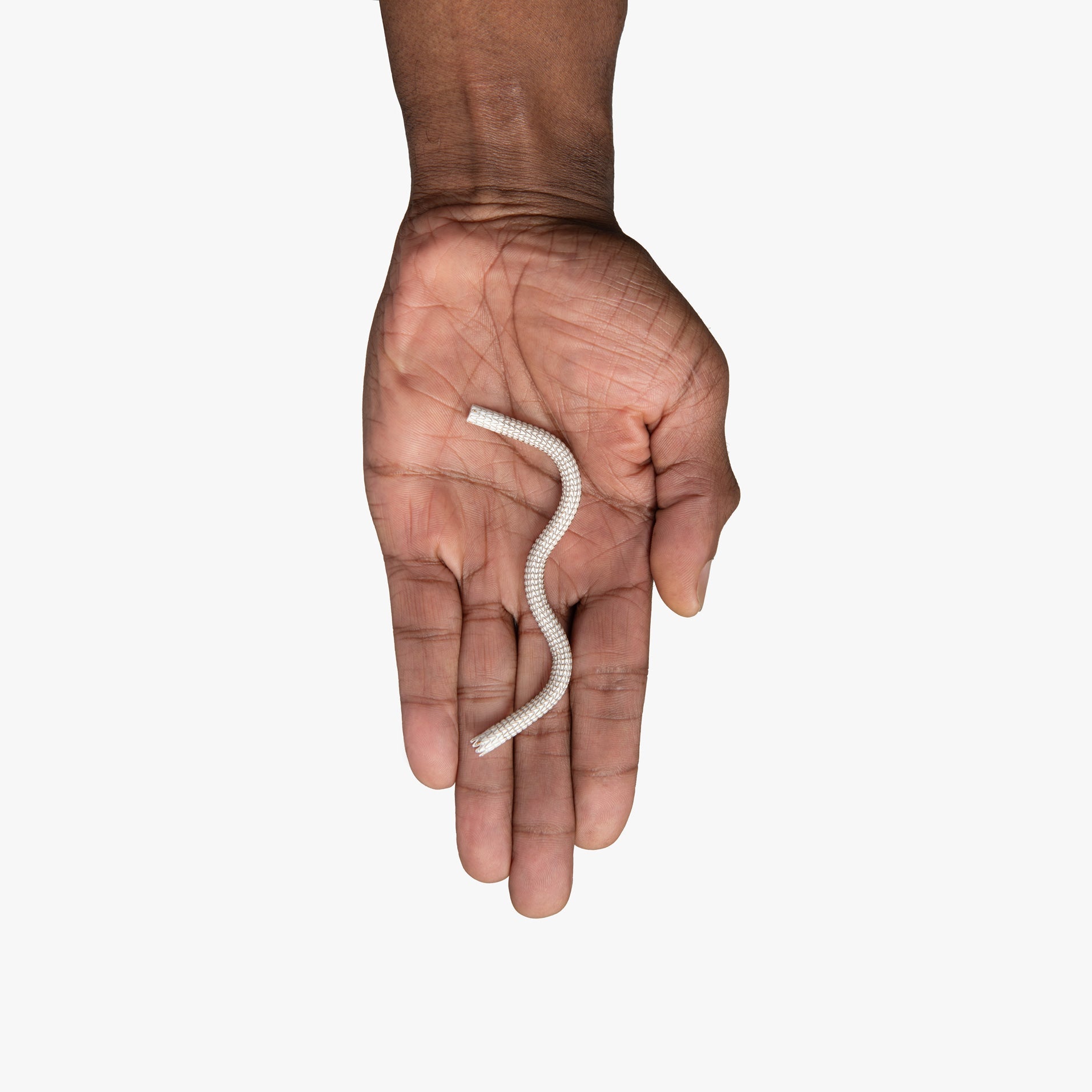 Close-up image of a hand holding the GORE® VIABAHN® Endoprosthesis with PROPATEN Bioactive Surface stent graft device