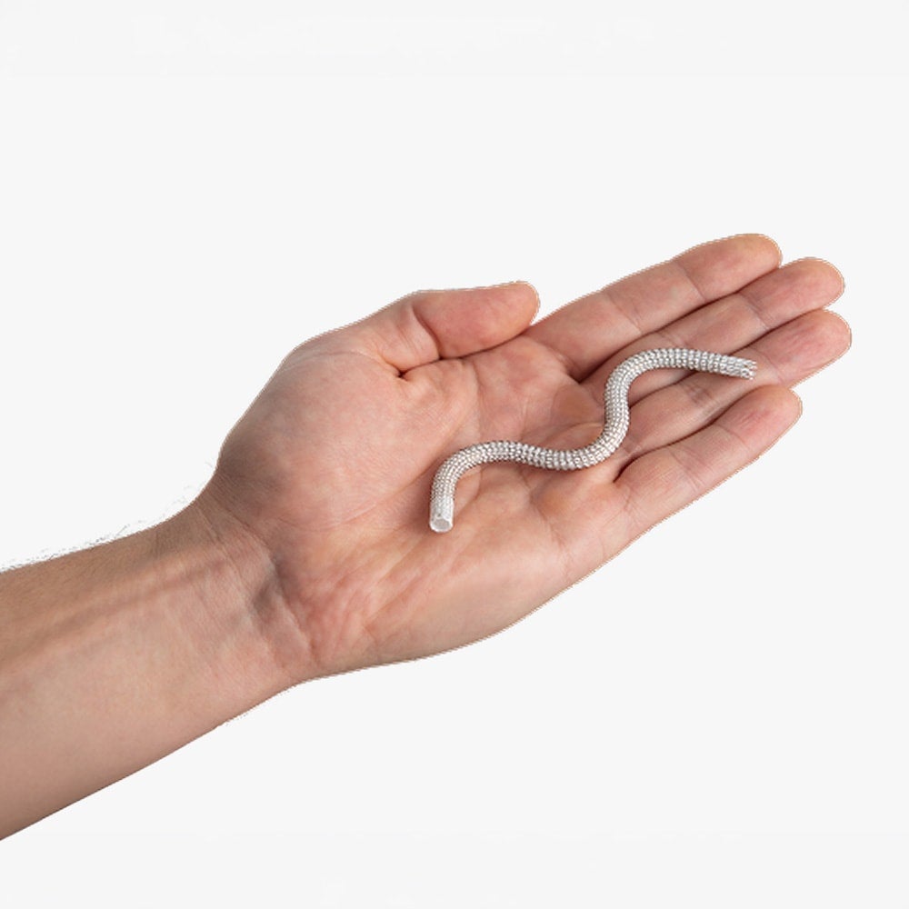 Close-up image of a hand holding the GORE® VIABAHN® Endoprosthesis with PROPATEN Bioactive Surface stent graft device