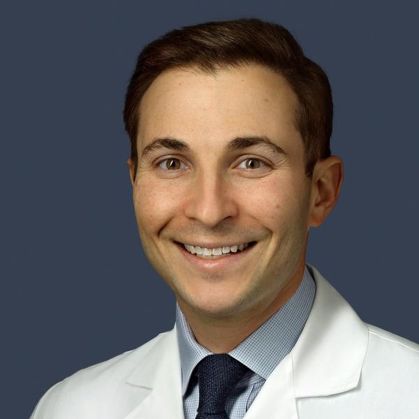 Portrait of Dr. Steven Abramowitz in a white coat.