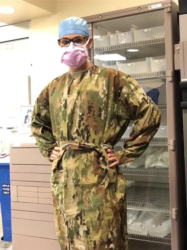 person in camouflage PPE