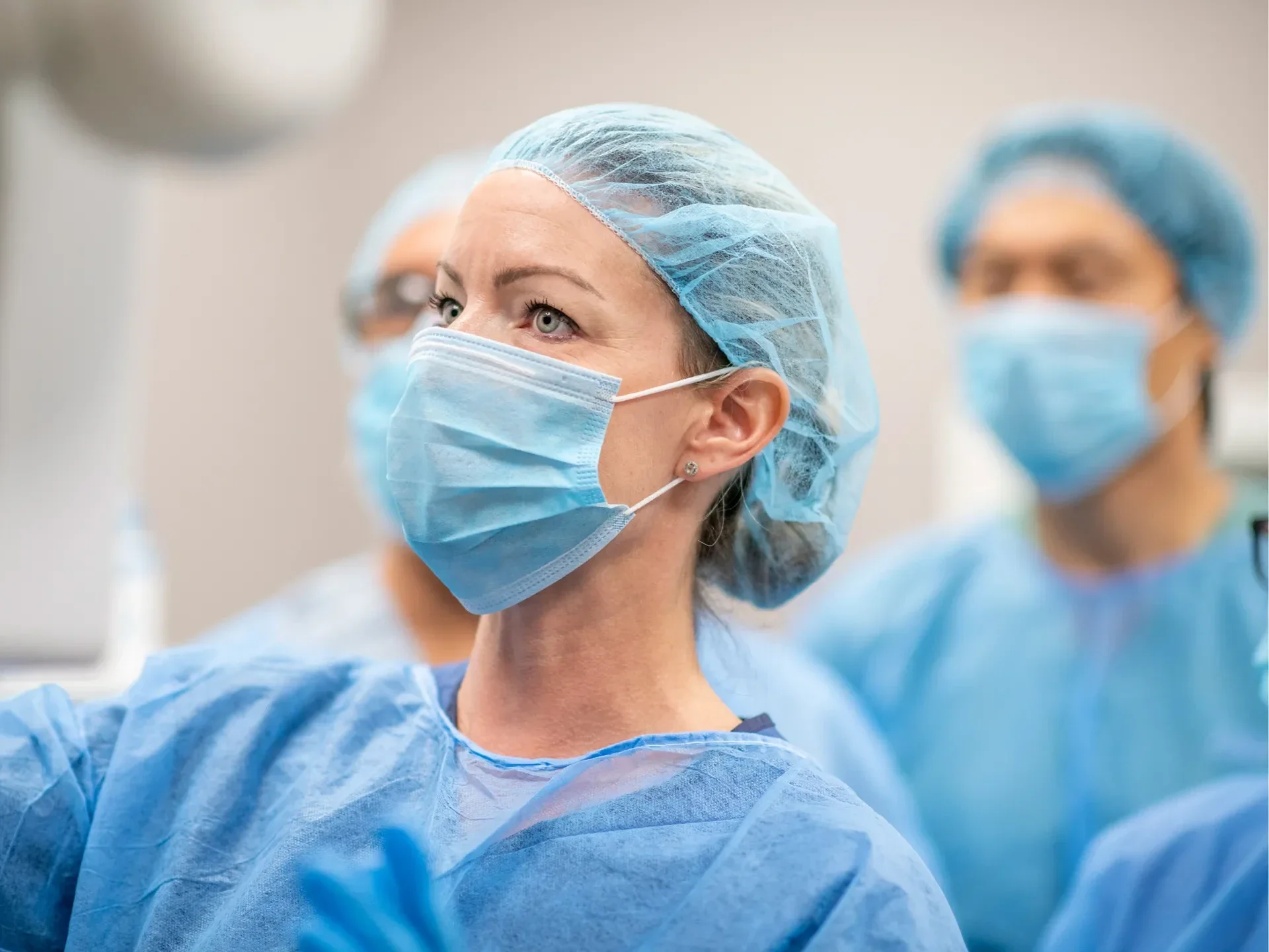 Group of doctors in surgical gowns and masks