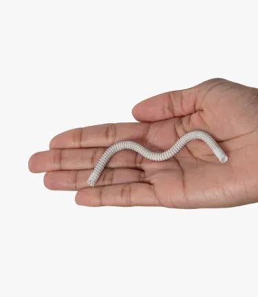 Close-up image of a hand holding the GORE® VIABAHN® Endoprosthesis with PROPATEN Bioactive Surface stent graft device