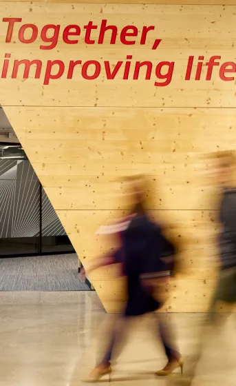 two associates walking in front of the gore together improving life