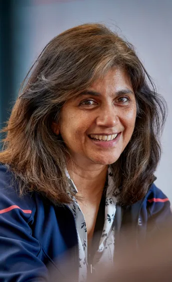 close up of woman smiling and talking at desk