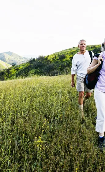 two people walking through a field