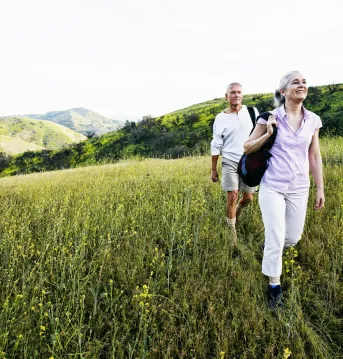 two people walking through a field