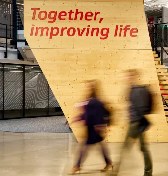 two associates walking in front of the gore together improving life