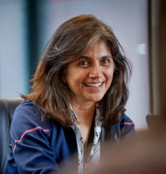 close up of woman smiling and talking at desk