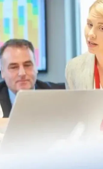doctors and business people in a meeting looking at a computer
