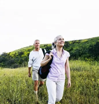 two people walking through a field